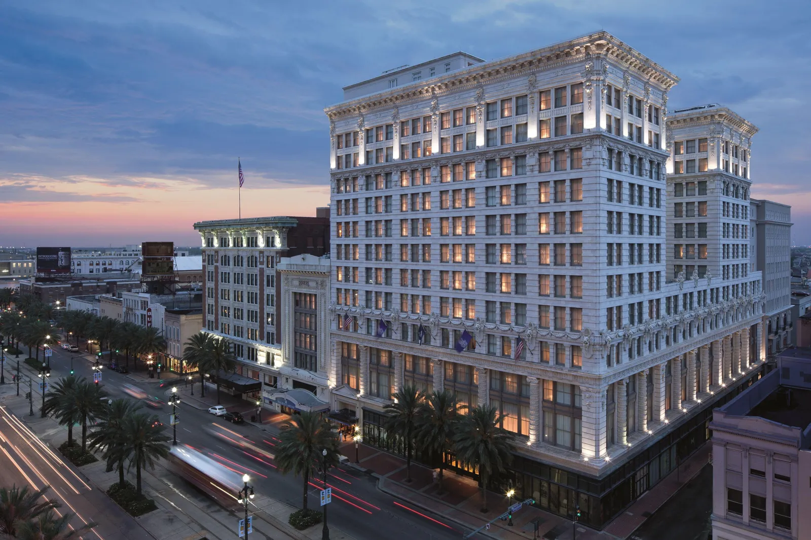 The exterior of a luxury hotel at dusk